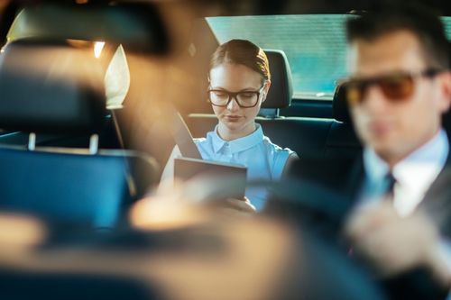 airport transfer woman and chauffeur in a car